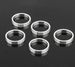 Five Aluminium spacer rings on a black background