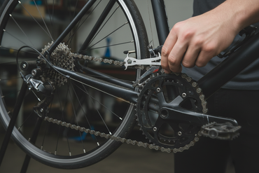 chain wear checker in a cyclists hand testing on a bike chain