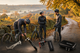 three cyclists on an Autumn day fixing a puncture with velotool products in the foreground