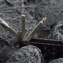 Close-up of a metal anchor embedded in stone
