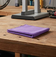 Folded purple towel on a white background