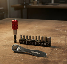 Set of Velo-tool screwdrivers and a wrench on a wooden surface