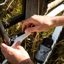 Person adjusting a bicycle