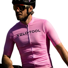 Person wearing a pink and purple cycling jersey with 