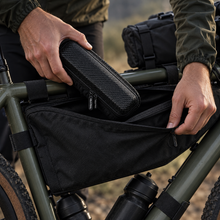 Case being inserted into a bike frame bag