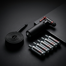 Dark studio product photo of the Velo-Tool CO2 pump kit with cartridges and inner tube
